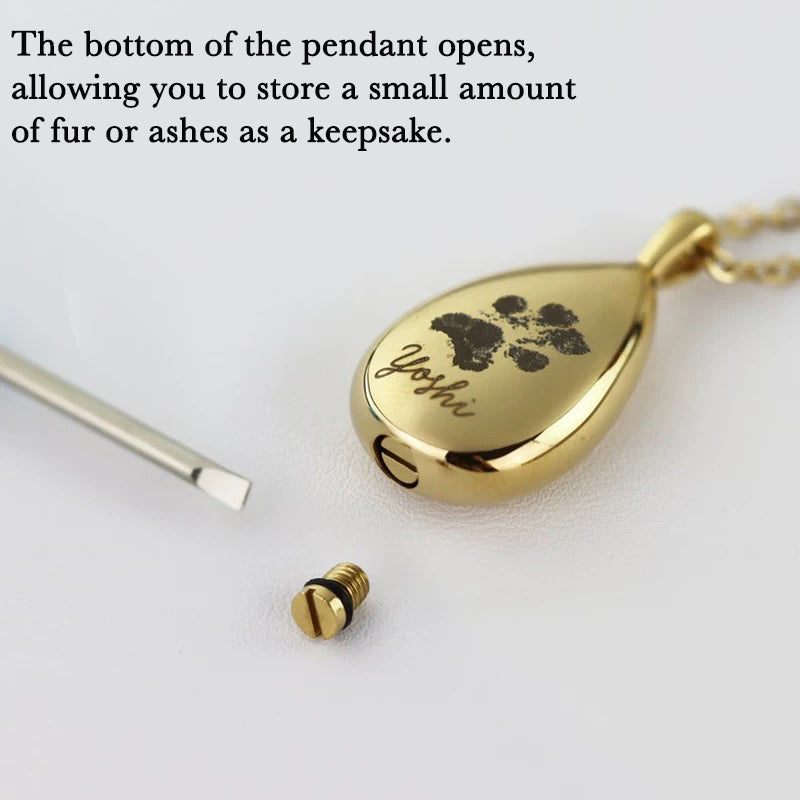 Gold pendant with paw print design 