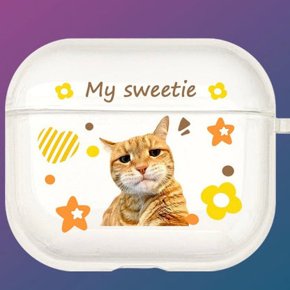 A custom AirPods case with a cat's face and the text 'My sweetie', along with decorative flowers and hearts.