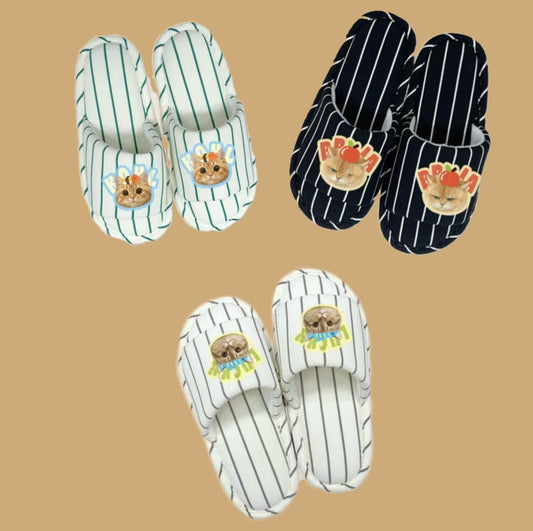 Three pairs of slippers with cartoon cats designs on a beige background
