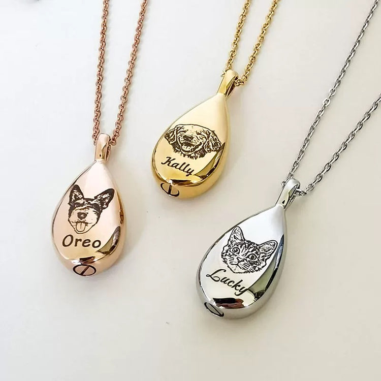 Three teardrop-shaped pet memorials with engraved dog faces and names on rose gold, gold, and silver chains.