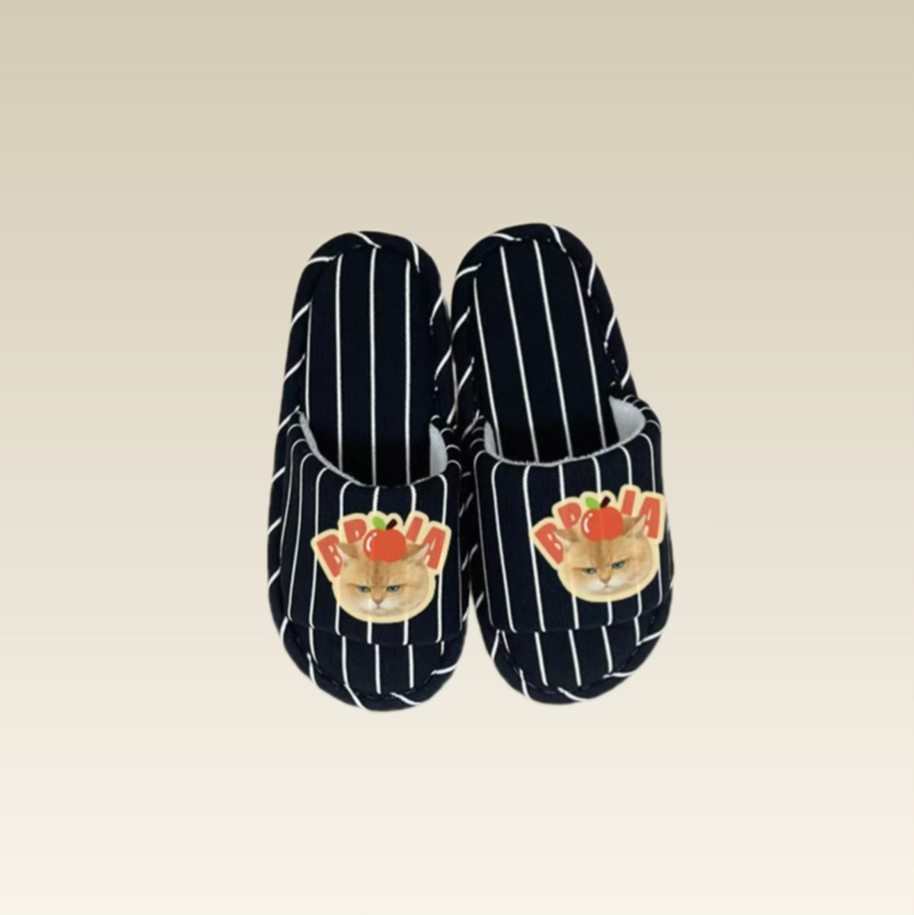 Pair of open-toe slippers with cat design on a beige background