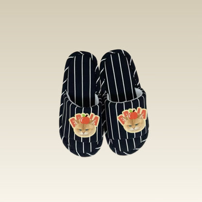 Pair of open-toe slippers with cat design on a beige background