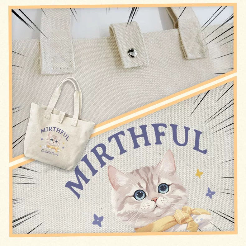 A custom tote bag with a printed cartoon image of a cat's face on it, alongside a smaller tote bag with pet name.