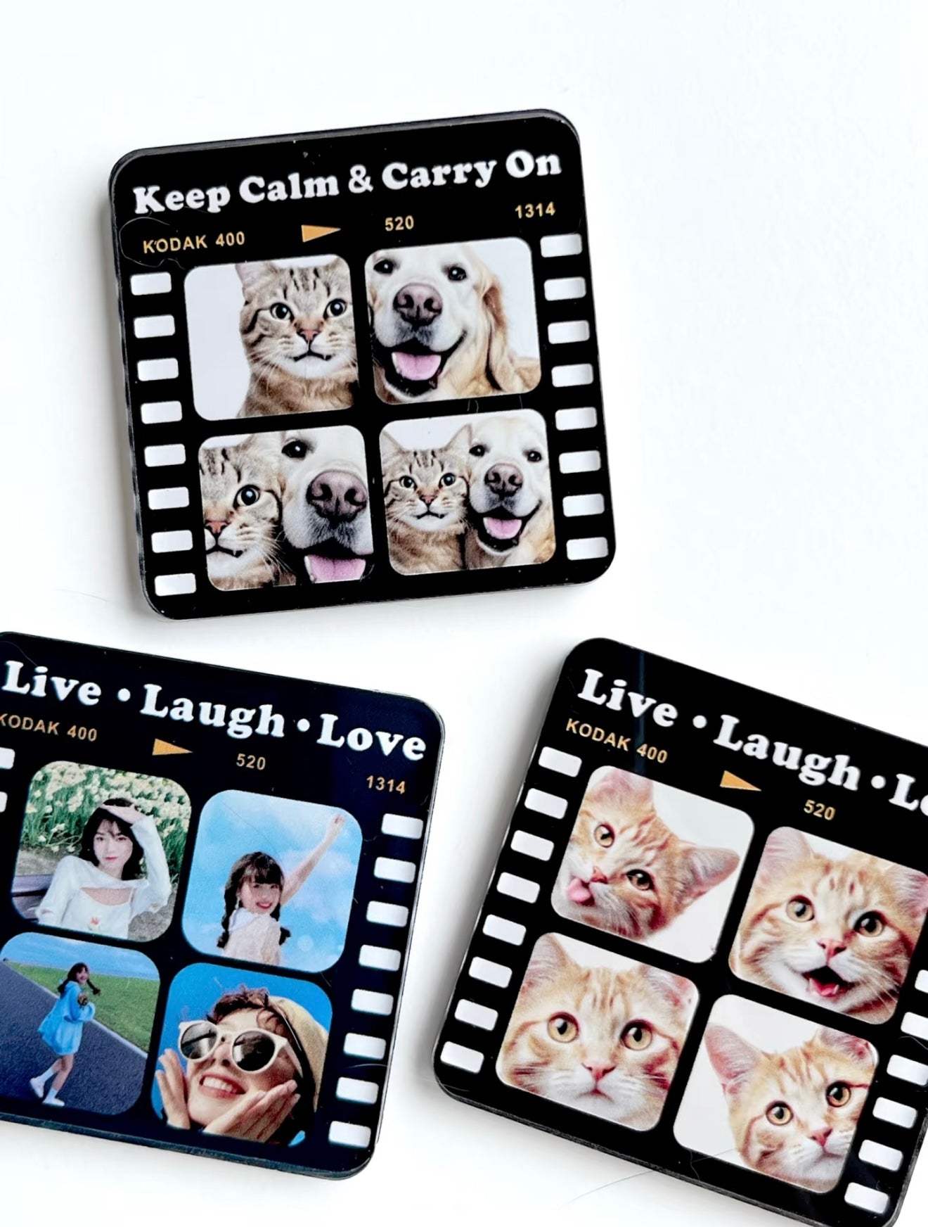Three black film strip coasters with various photos of people and animals on a white background.