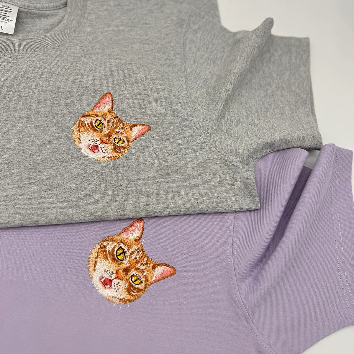 gray and purple personalized embroidered T-shirts with a unisex design, featuring an embroidered image of a cat on the front.