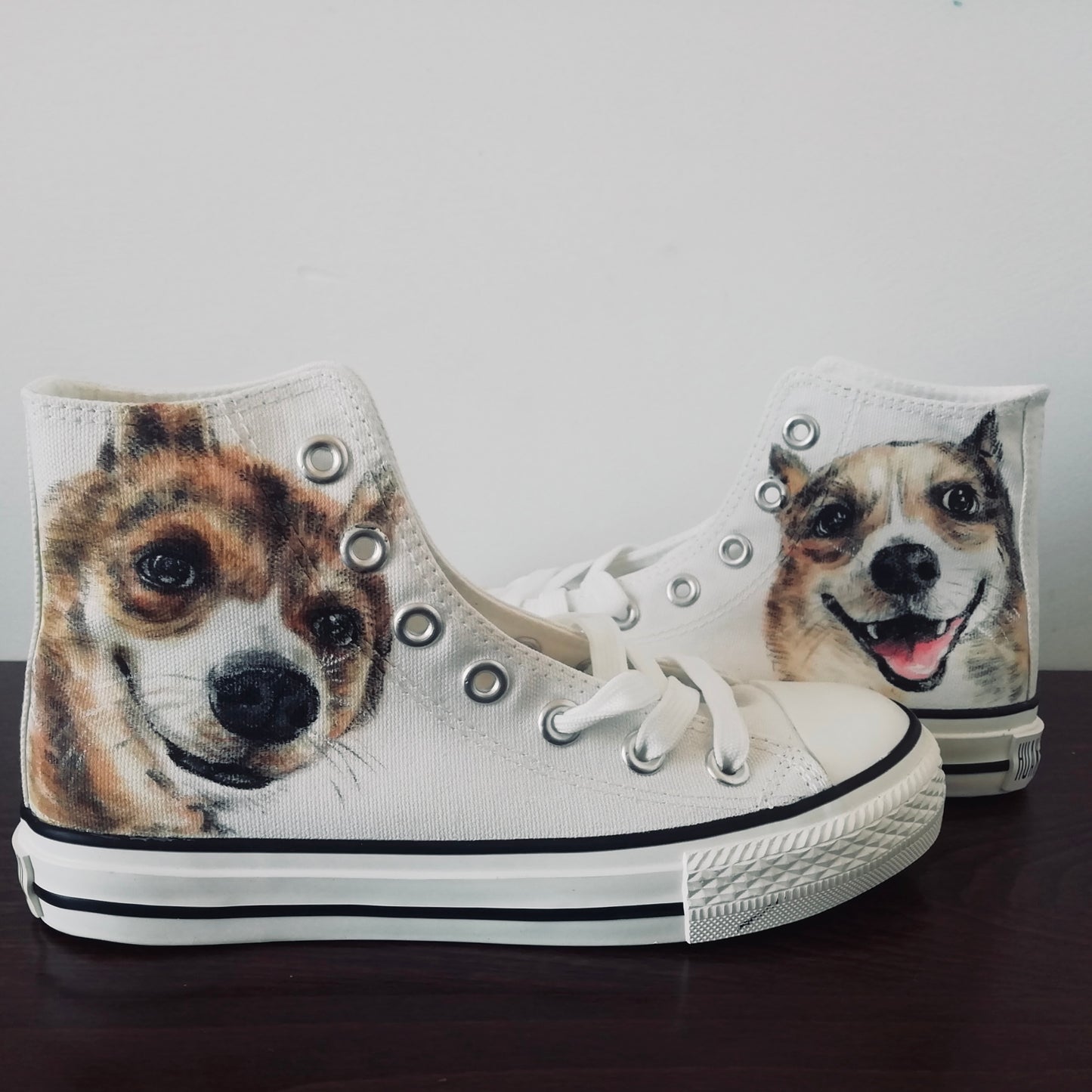A pair of hand-painted canvas high-top sneakers featuring an illustration of two dogs on a white background, with lace-up closure.