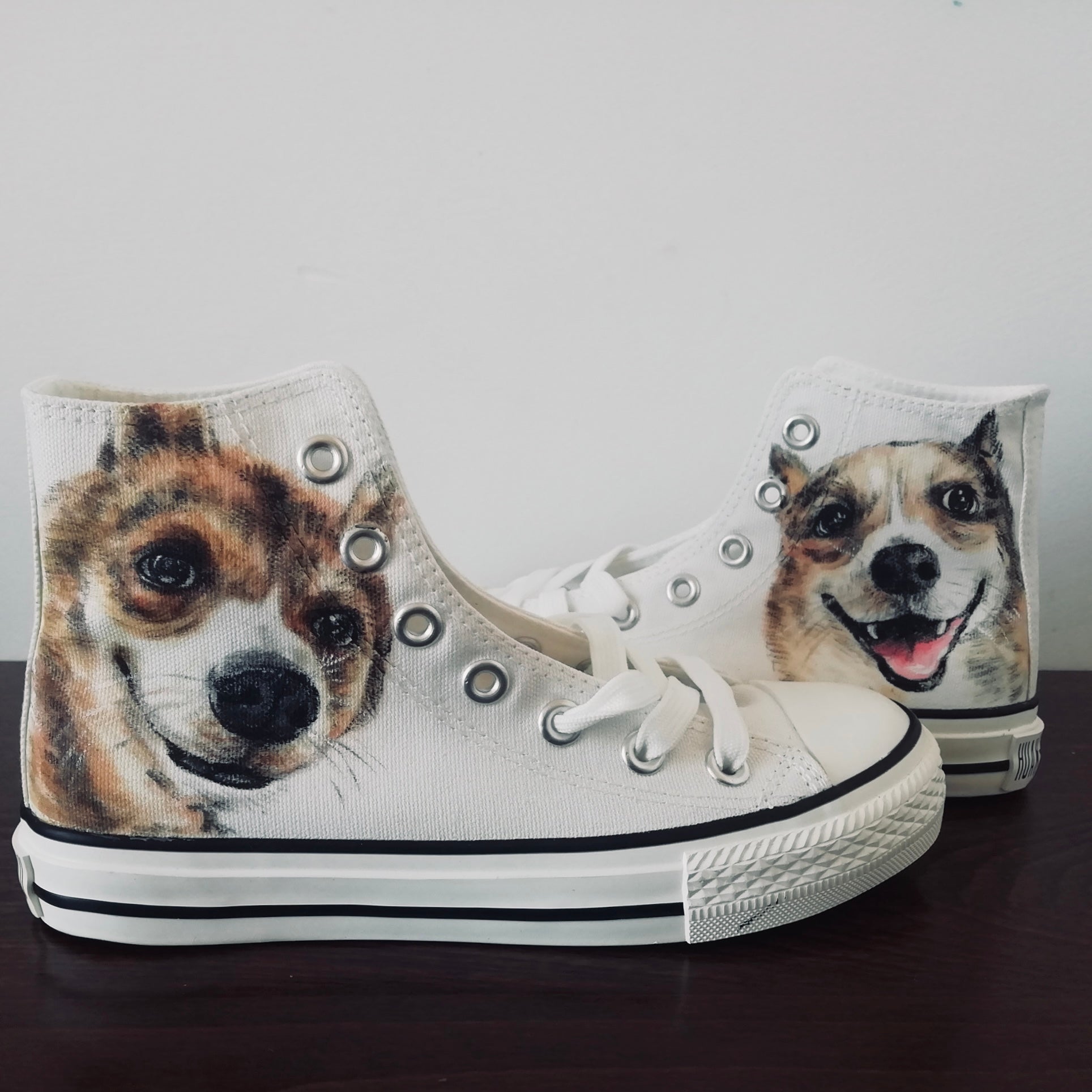 A pair of hand-painted canvas high-top sneakers featuring an illustration of two dogs on a white background, with lace-up closure.